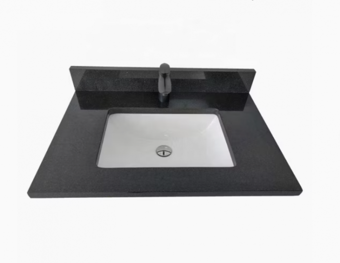 A sleek black granite sink on a white countertop.
