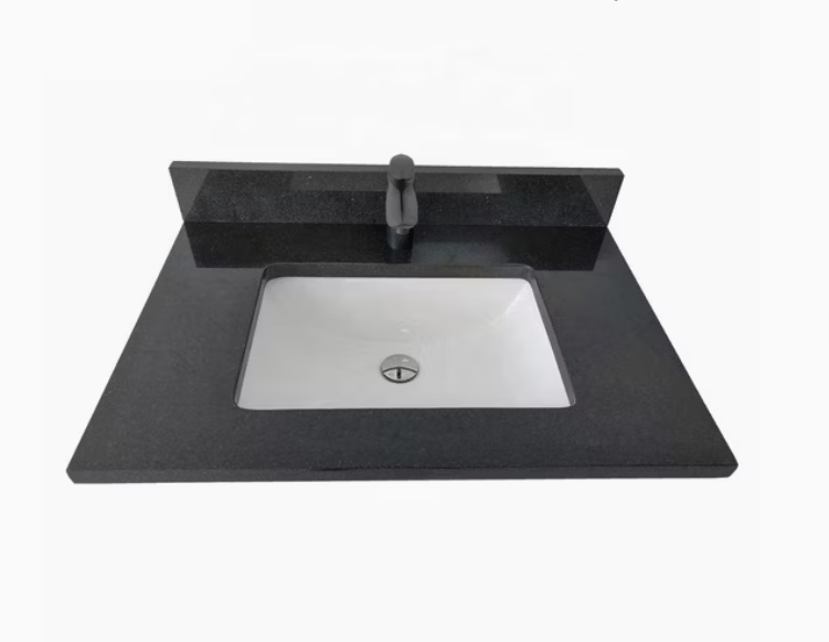 A sleek black granite sink on a white countertop.