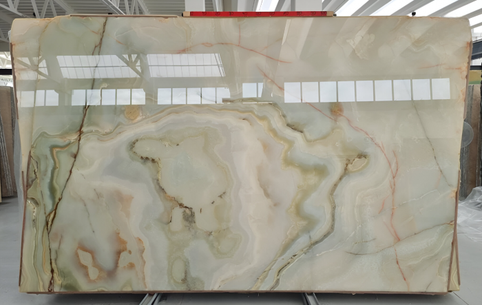Large marble slab with intricate green and white design.